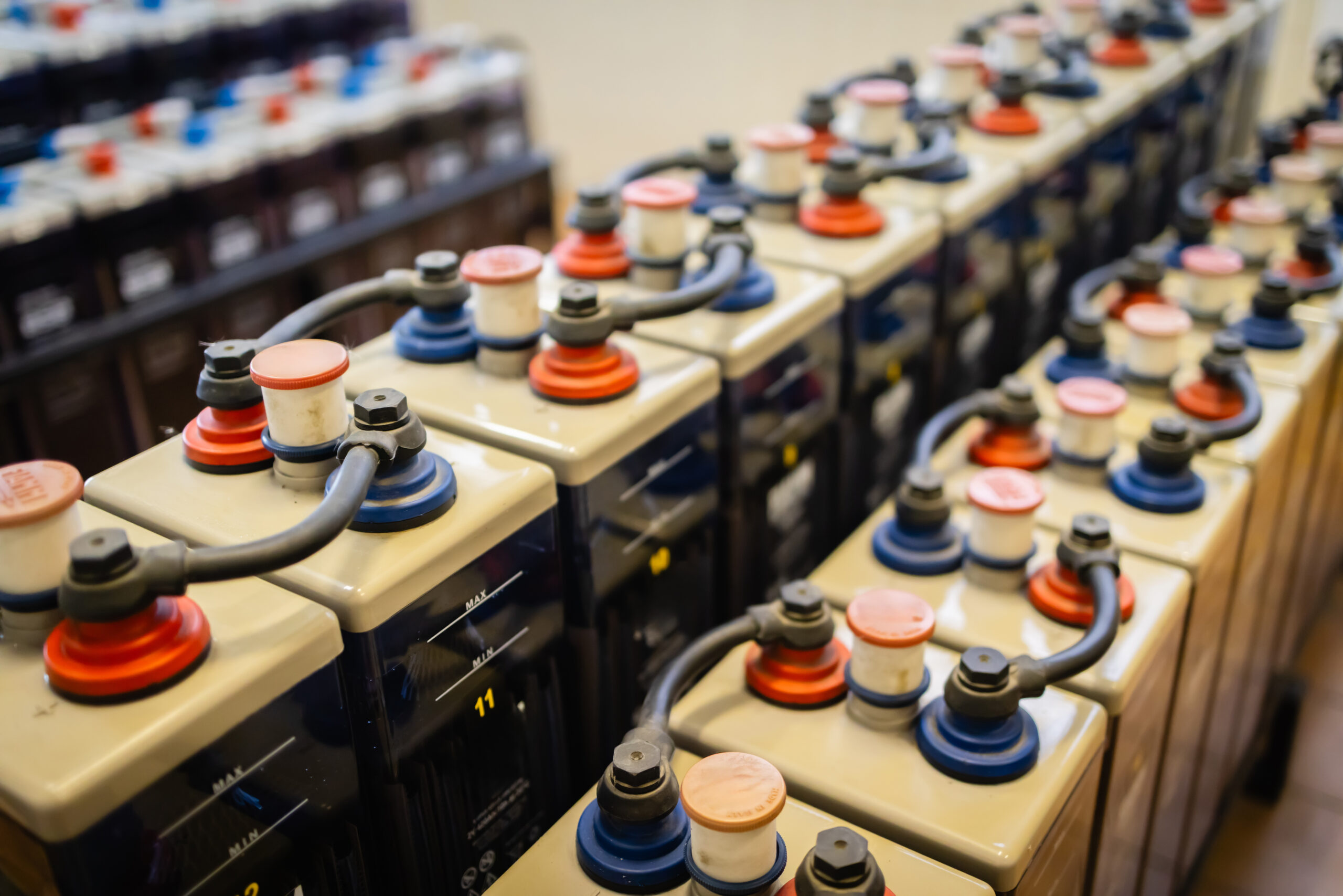 Solid-state battery interface showcasing multiple battery modules connected by cables. The modules are arranged in a row and feature color-coded connectors.